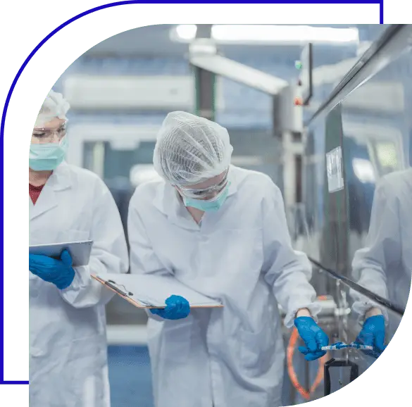 Two inspectors looking over food production facillity.