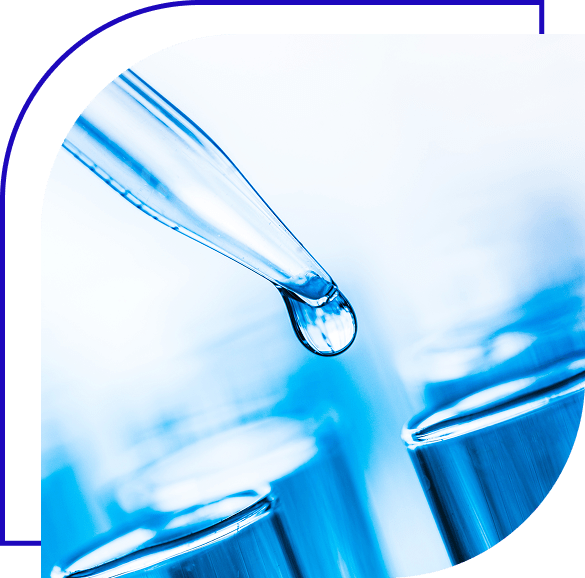Close up view of pipette with liquid drop on edge.